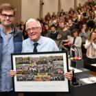 Law student Tim Austen presents lecturer Prof Mark Henaghan with a board of finalists' pictures...
