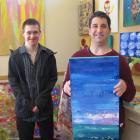 Living Options artists Logan Winter (left) and Andrew Wallace display some of the work that will...
