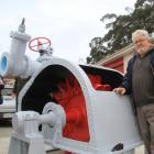 Oamaru heritage engineering advocate Bruce Comfort with an original Pelton wheel turbine which he...