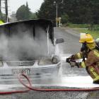 Firefighters from the Weston Volunteer Fire Brigade extinguish a car fire in Main Rd at Weston...