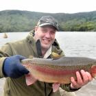 Otago Fish &amp; Game Council field officer and hatchery manager Steve Dixon prepares to release...