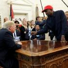 Rapper Kanye West shows President Trump his mobile phone during meeting in the Oval Office. Photo...