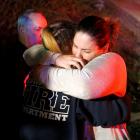 People comfort each other after a mass shooting at a bar in Thousand Oaks. Photo: Reuters