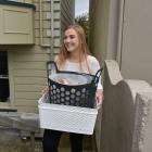 Student Chloe Hedges (20) carries her belongings to a removal truck yesterday morning. PHOTO:...