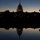 The US Capitol is reflected in a puddle of water a day after Americans voted in the midterm...