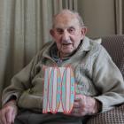 Southland man Tom Johnstone shows one of the many cards he received ahead of his 100th birthday....