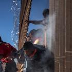 Migrants are hit by tear gas by US Customs and Border Protection after attempting to illegally...