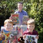 Comic book diehard Liam Hartnett (centre) and his two sons Aodhan (5) and Finn (9) showcase their...