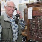 Teviot District Museum committee member Robin Christie displays the old telephone exchange used...