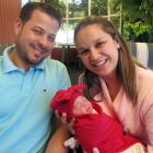 Robson Pacheco and Daiane Brazil Foggiato cradle their Christmas Day baby, Elena, who was born at...