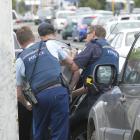 Police arrest a man after he evaded police at a check point in Dunedin this afternoon. Photo:...