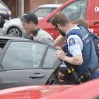 Police arrest a man after he evaded police at a checkpoint in Dunedin yesterday afternoon. Photo:...