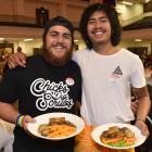 Enjoying their first Christmas meal away from home are Samoan students Drew Chu Shing (left) and...
