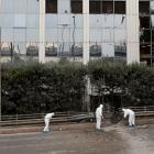 Forensic experts search for evidence after a bomb blast outside SKAI TV building in Athens. Photo...
