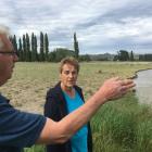 Ophir residents Malcolm Topliss  and Irene Leask  investigate the damage caused to local farmland...