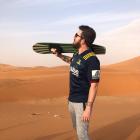 Billy Heron sports his Highlanders shirt while sandboarding. Photo: Matthew Wicks