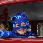 Waving to the crowd from inside a vintage fire appliance is Jamieson Loader (5). Photo: Gregor...