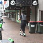 A Lime scooter user in central Dunedin on Thursday morning. Photo: Gregor Richardson