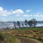 Smoke blankets the scene after a fire broke out at a Clutha farm today. Photo: Richard Davison