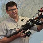 Otago Fish and Game chief executive Ian Hadland holds rods confiscated from unlicensed anglers....