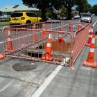 Motorists negotiate a fenced-off sinkhole in Reed St that opened up in late December. Work to...