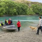 The dog's owners thank rescuers after being reunited with their pet. Photo: Todd Weeks