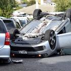 Dunedin police stop traffic on Kenmure Rd after a stolen car crashed and rolled on Sunday. PHOTO:...