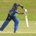 University-Grange batsman Jithendra Ratnayake plays a drive during a senior one-day game against...