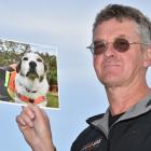 LandSAR volunteer Dermot Mayock holds a picture taken of him and his dog, Fin, when Fin retired...