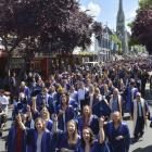 Otago Polytechnic graduands celebrate their success during the graduation march along George St,...