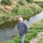 Ray McCrostie stands by the Waituna Stream which runs through his property. Photo: Ken Muir