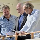 Catholic Bishop of Dunedin the Most Rev Michael Dooley (centre) reads a new memorandum of...