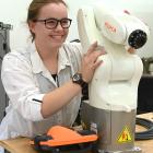 Aspiring electrical engineer Hanri de Bruin poses with an automated arm, similar to the one she...