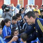 Ben Smith shakes a noy's hand as he arrives with the Highlanders at the Al Huda mosque in Dunedin...