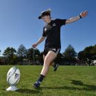 Black Ferns halfback Kendra Cocksedge boots a ball during a kicking session at the North Ground...