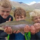 Noah Elder (10), Fletcher Melville (9), and Jordy Elder (6) show off their catch of the day after fishing at Lake Ohau. Photo: Mark Elder
