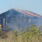 Firefighters work to put out a shed fire in Regina Lane in north Oamaru this afternoon. Photo:...