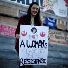 A woman holds a banner during a gathering to mark International Women's Day in Lisbon, Portugal....