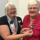 Mavis Wilkins, of Lowcliffe Women's Institute (WI), is given her WI 50-year pin by outgoing Mid...