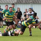 Green Island No8 Lafele Fa'amoe is tackled by Southern fullback Bryce Hosie (on ground) as Josh...