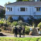 Police armed offenders personnel search the property in Somerville St, Dunedin, on Saturday....