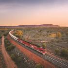 The Ghan heads north from Alice Springs, the MacDonnell Ranges in the background.PHOTO: GREAT...