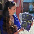 WoolOn Creative Fashion Event educational specialist Mary Hinsen looks over posters promoting...