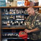 Holding a coffin sash bearing a swastika at his Palmerston shop, Barry White has no plans to stop...