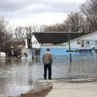 A man looks out at a flooded residential area in Gatineau, Quebec, Canada. Photo: Reuters