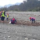 South Westland Coastal Cleanup volunteers helping clear litter and detritus swept into rivers and...
