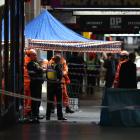 Police and scene examination personnel at the site of a homicide in Melbourne's CBD late last...