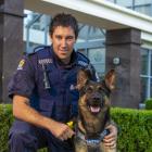 Constable Marcus Saunders and patrol dog Vann outside the Dunedin Central Police Station. Photo:...