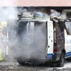 Members of the Wanaka Volunteer Fire Brigade work to put out a Wanaka Solar van that caught fire...