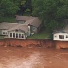 Homes close to a swollen Cimarron River near Crescent, Oklahoma. Photo (via video): AP